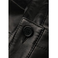Close-up of genuine black leather texture and fine stitching on women’s casual high-waist shorts.