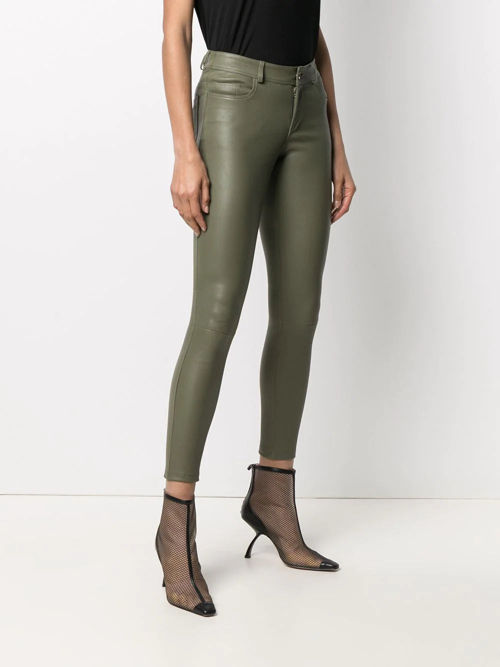 Side angle showing fitted silhouette of Women's Olive Green Leather Pants - Slim Fit Lambskin.