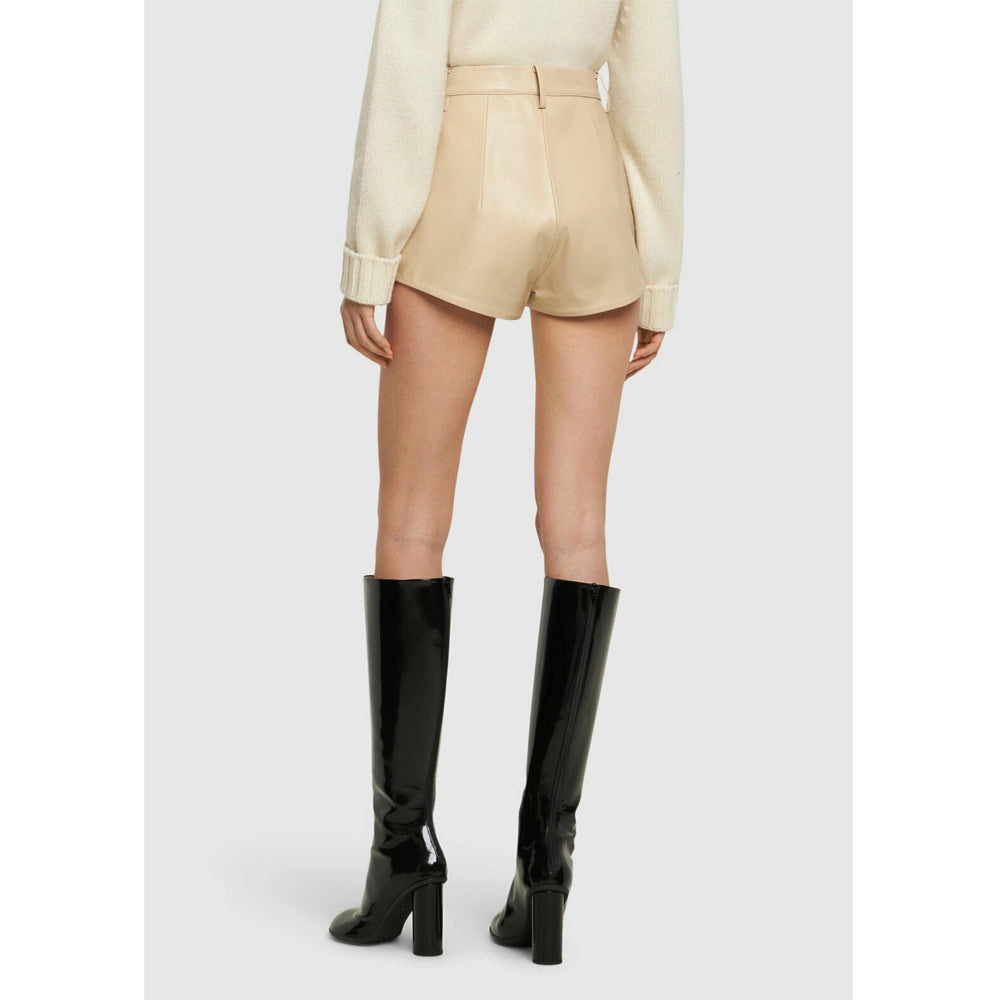 Model styling beige real leather high waist shorts with heels.