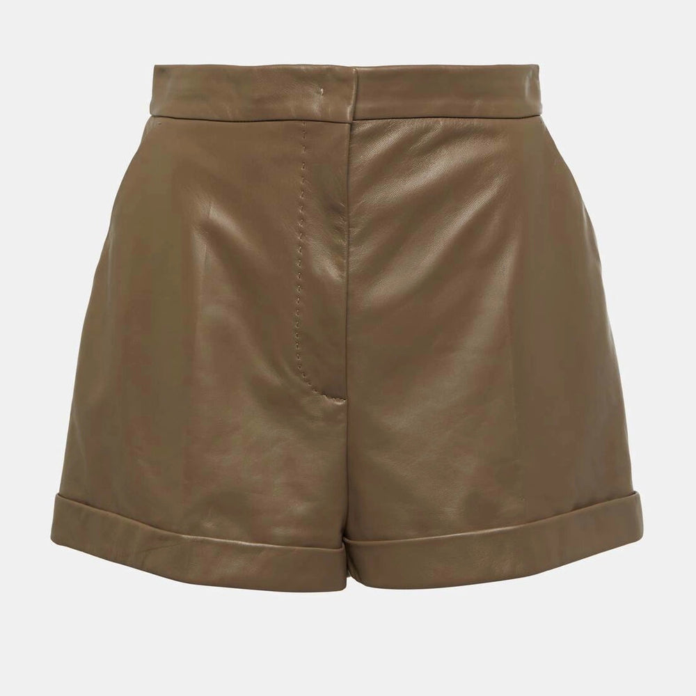 Detailed close-up of soft brown leather texture and stitching on high-waisted women’s shorts.