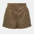 Detailed close-up of soft brown leather texture and stitching on high-waisted women’s shorts.