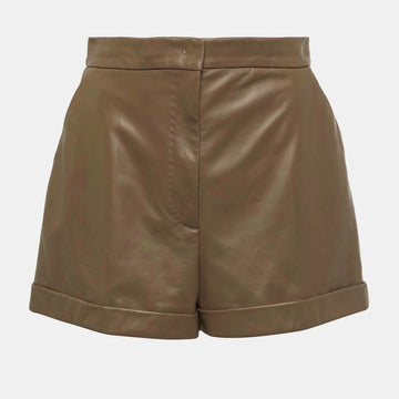 Detailed close-up of soft brown leather texture and stitching on high-waisted women’s shorts.