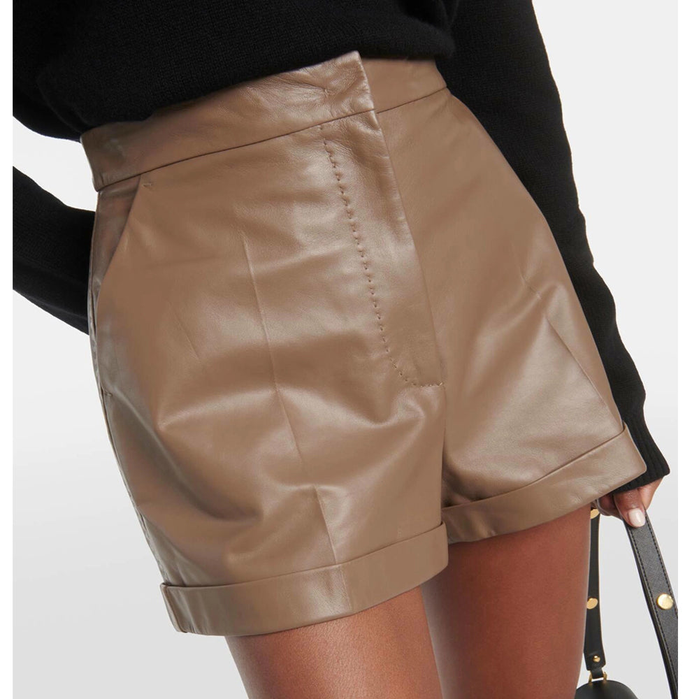 Detailed close-up of soft brown leather texture and stitching on high-waisted women’s shorts.