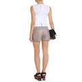 Close-up of premium taupe leather texture and designer stitching on women’s high-rise shorts.