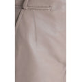 Close-up of premium taupe leather texture and designer stitching on women’s high-rise shorts.