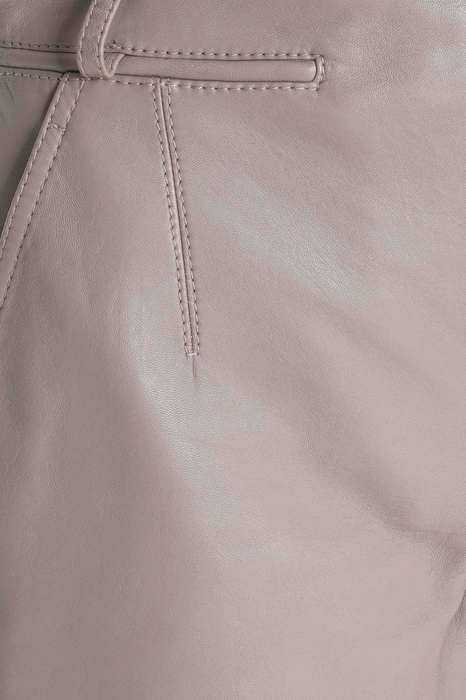 Close-up of curved stitching and premium leather texture.