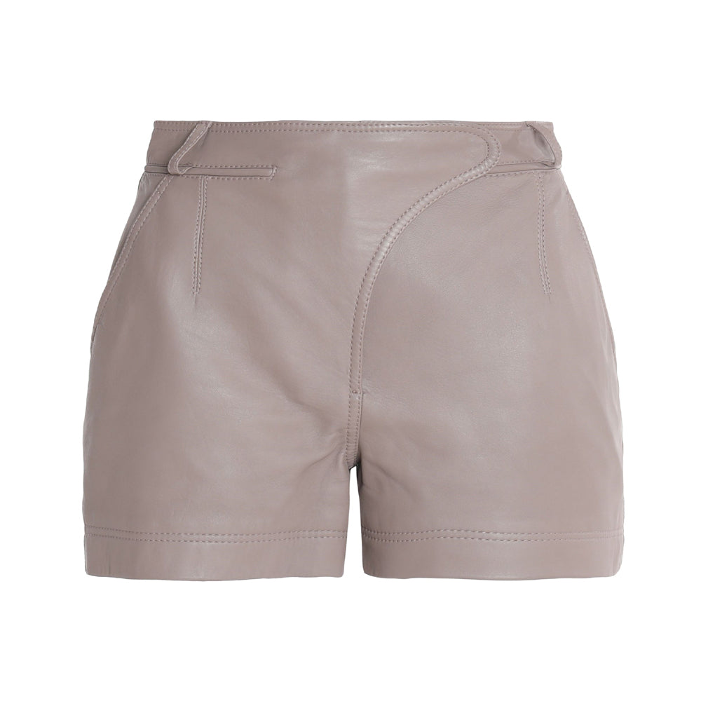 Model wearing women’s real leather taupe shorts styled with boots and a jacket for a modern chic look.